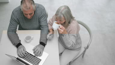 Senior couple looking at photo of daughter on a smartphone