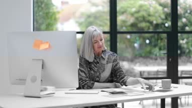 Senior woman cutting fruit for a smoothie