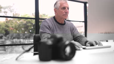 Senior woman looking at reflection in mirror