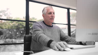 Senior woman looking out of window thinking
