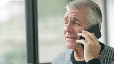 Senior woman looking out of window thinking
