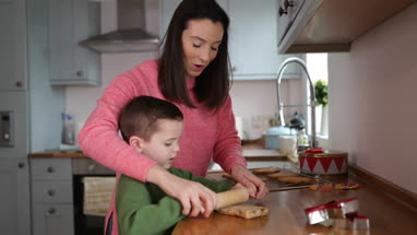 Mother and Son baking cookies in kitchen