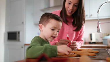 Mother and Son decorating gingerbread men