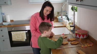 Mother and Son decorating gingerbread men