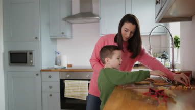 Mother and Son decorating gingerbread men