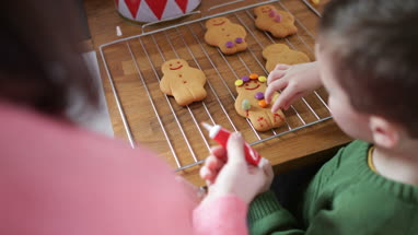 Mother and Son decorating gingerbread men