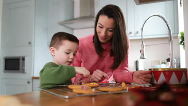 Mother and Son decorating gingerbread men
