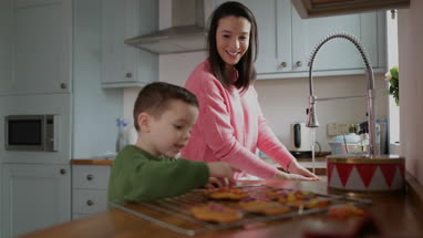 Mother and Son baking cookies in kitchen