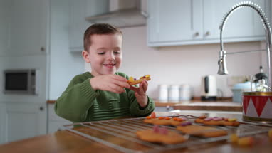 Boy eating gingerbread man