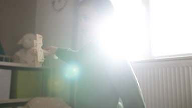 Boy playing with toy model plane