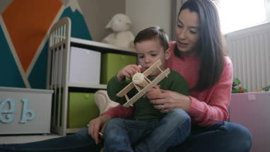 Mother and Son playing with toy model plane