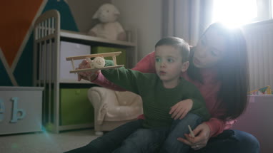 Mother and Son playing with toy model plane