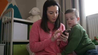 Mother and Son looking at smartphone