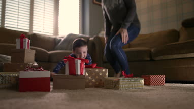 Boy excited on Christmas morning to open presents