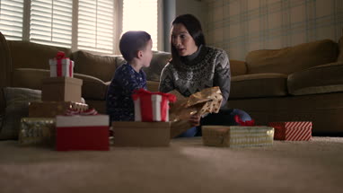 Mother and Son unwrapping Christmas gifts