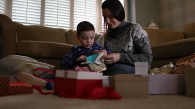 Mother and Son unwrapping Christmas gifts