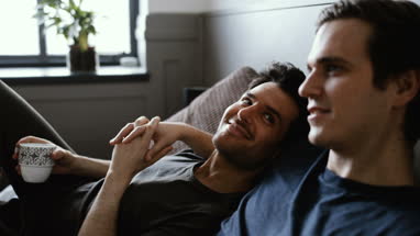 Young male couple relaxing with coffee