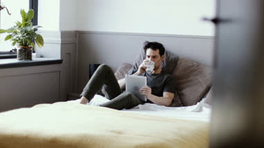 Young male reading on digital tablet