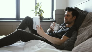 Young male reading on digital tablet