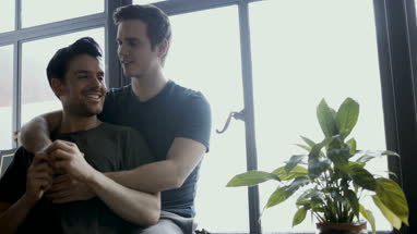 Young male couple in each others arms