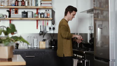 Young male cooking in kitchen