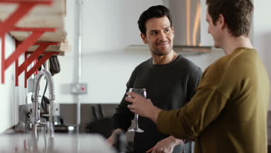 Young male couple cooking in kitchen