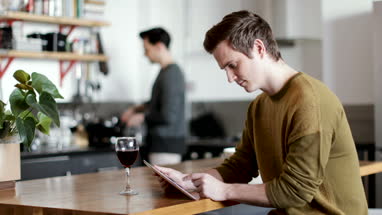 Young male using digital tablet at home