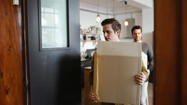 Young male couple moving home