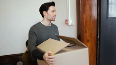 Young male couple moving home