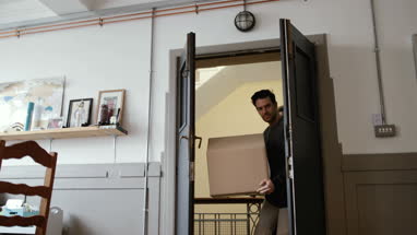 Young male couple moving home