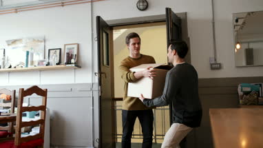 Young male couple moving in together