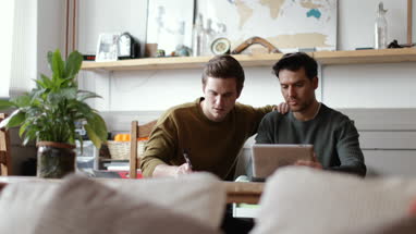 Young male couple completing mortgage application