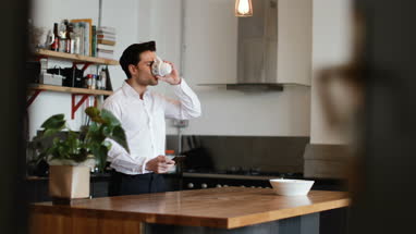Businessman checking smartphone at home