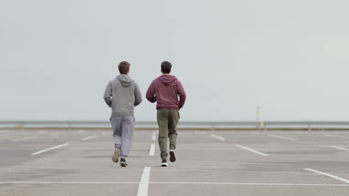 Male friends jogging outdoors