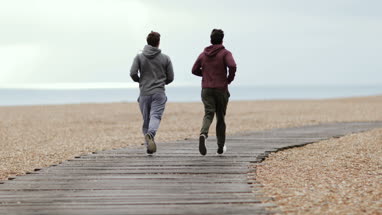 Male friends jogging outdoors