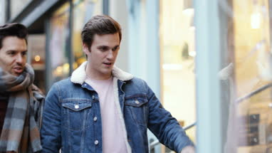 Young male couple window shopping