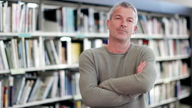 Portrait of mature student in college library