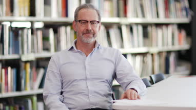 Portrait of mature student in college library