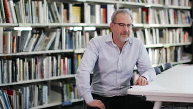 Senior male in college library