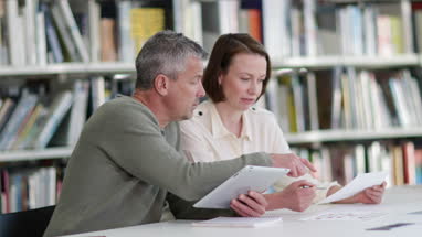 Mature students in library studying together