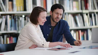 Mature students in library studying together