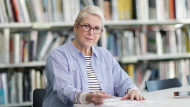 Portrait of senior student in college library