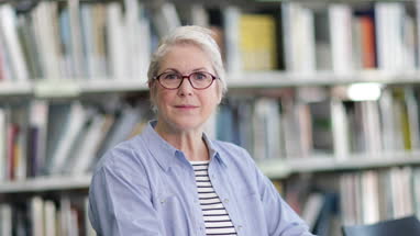 Portrait of senior student in college library