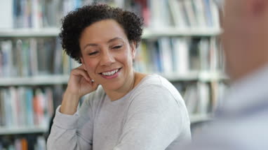 Mid adult female listening in a library