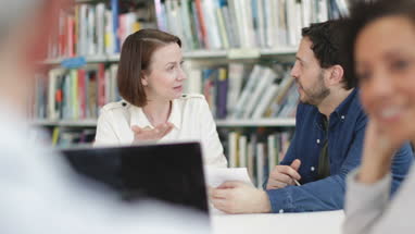 Mature students in library studying together
