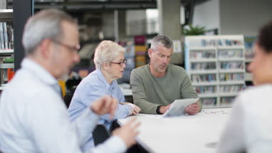 Senior woman learning how to use digital tablet