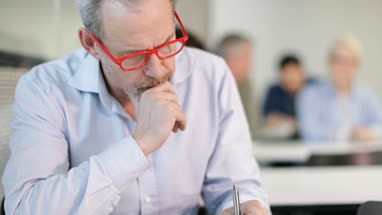 Senior student taking notes in a lecture