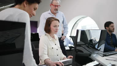 Team looking at computer in an office