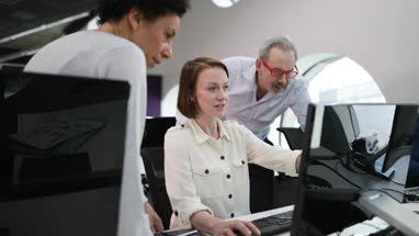 Team looking at computer in an office