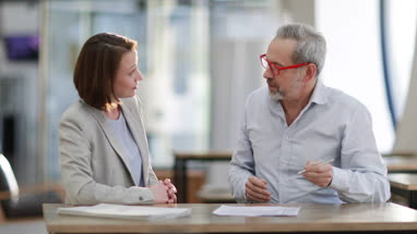 Senior man signing contract with personal finance advisor